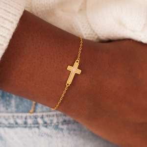 Elegant s925 silver gold bracelet with a white opal cross pendant on female model wrist