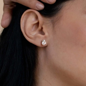 Minimalist S925 sterling silver oval cut cubic zirconia stud earrings worn by a model