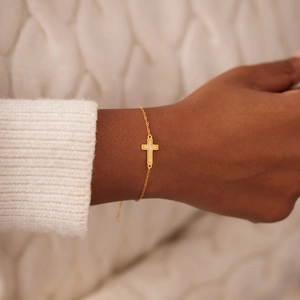 Minimalist s925 silver gold cross bracelet with opal inlay worn on a female wrist
