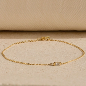 Detail of s925 silver gold plated bracelet featuring a rectangular step-cut zircon stone