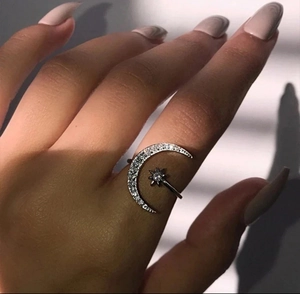 Detail of adjustable S925 sterling silver moon and star ring with sparkling crystals