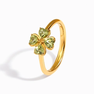 Close-up of green crystal four-leaf clover ring with 925 silver hallmark on gold band