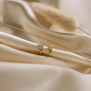 S925 silver marquise zircon clover earrings in gold finish on silk background