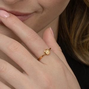 S925 sterling silver sun ring with opal stone center on woman's finger, golden finish