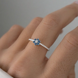 Elegant S925 silver ring featuring blue zircon flower cluster on a model's finger