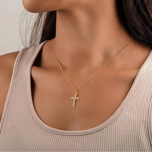 Elegant s925 silver gold cross necklace with cubic zirconia worn by a model