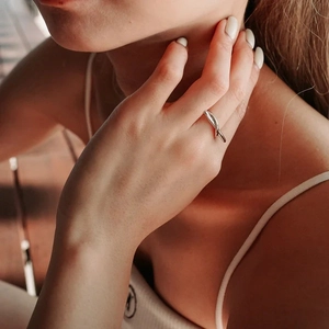 Detailed close-up of s925 silver adjustable twisted ring on finger with soft lighting
