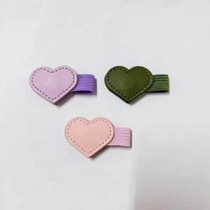 Detailed view of three heart leather magnetic bookmarks with pen loops and fine stitching