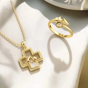 Detail of s925 silver gold-plated cross necklace and mountain-style open ring set