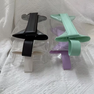 Detail view of transparent PVC travel bags with black, green, white and purple handles