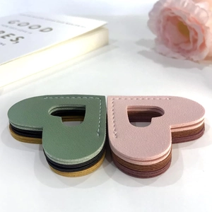 Handmade leather heart-shaped bookmarks in various colors with elegant stitching detail