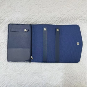 Navy blue foldable jewelry travel roll showing earring strap and necklace snap holders