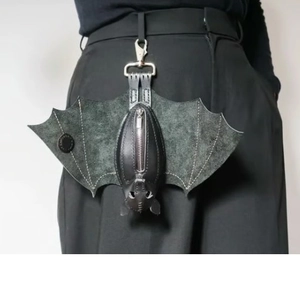 Handmade black leather bat coin purse with silver clasp worn as a gothic keychain accessory