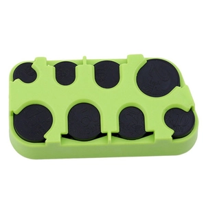 Macro view of green plastic coin organizer with eight slots for sorting euro coins