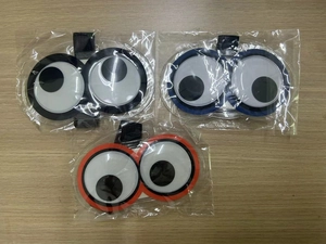 Detailed view of three colorful cartoon eye luggage tags with durable nylon straps