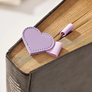 Detail view of purple leather heart-shaped magnetic bookmark with elastic pen holder loop