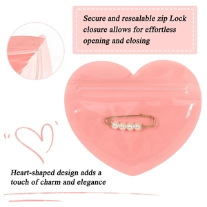 Pink heart-shaped PVC self-sealing bag with white pearl pin accessory for jewelry