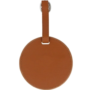 Tan leather golf tee holder with circular design and polished silver buckle strap