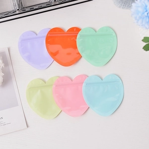 Macro view of colorful heart-shaped PVC storage bags with secure zip-lock closures