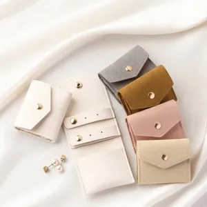 Portable microfiber jewelry pouches in various colors with metallic snap button closure