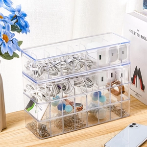 Macro view of stackable clear cable organizer with compartments for storage and accessories