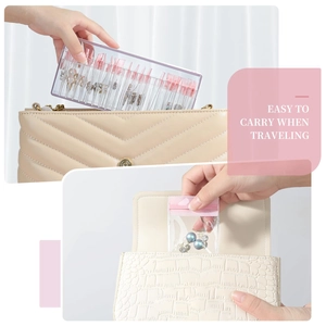 Portable acrylic jewelry box with pink PVC bags fitting easily into a travel handbag