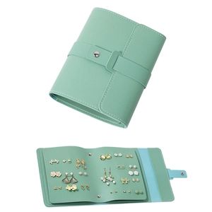 Detail view of mint green loose-leaf earring organizer with lychee grain and silver button