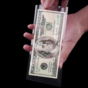 High transparency plastic currency sleeves for banknotes held against a dark background