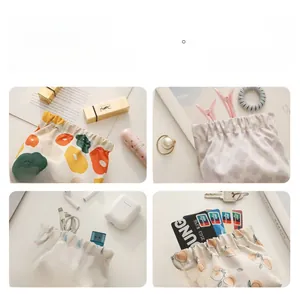 Detail showing printed fabric pouches used for storing lipstick, coins and jewelry