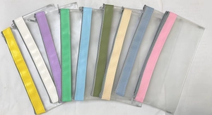 Macro view of multi-color transparent PVC zipper bags for stationery and travel storage