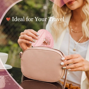 Pink heart-shaped PVC jewelry pouch for travel being placed in a beige handbag