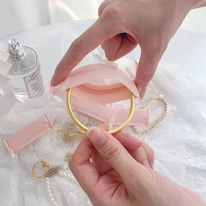 Transparent PVC jewelry bag for organizing golden bracelets with pink zip lock seal