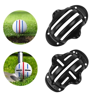 Close-up of black golf ball marker tools showing alignment slot details and line patterns
