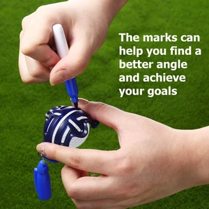 Close-up of hands using a blue golf ball marker tool to draw precise lines on a golf ball