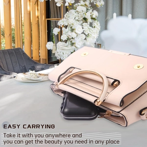 Portable double-layer waterproof black jewelry box shown being placed in a stylish handbag
