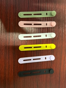 Detailed view of colorful silicone cable ties for wire management on wooden background