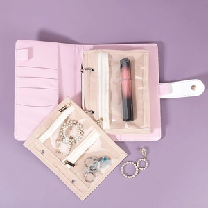 Pink portable jewelry organizer book with transparent PVC zipper bags and snap closure