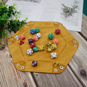 Hexagonal mustard yellow dice tray with folding metal snaps and colorful dice set