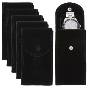 Set of 6 black velvet watch pouches with metal snaps showing luxury watch storage detail