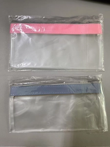 Close-up of frosted PVC stationery bags with pink and blue zipper details in packaging