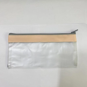 Top-down view of clear frosted PVC pencil case with beige trim and metal zipper