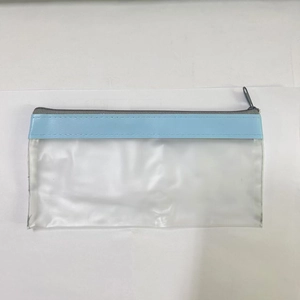Detail view of transparent PVC pencil case with light blue trim and grey zipper closure
