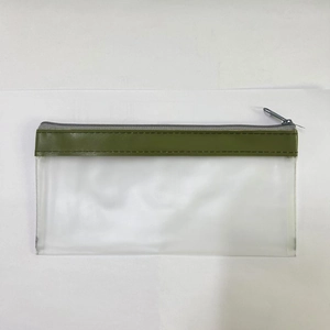 Macro shot of durable transparent PVC mesh bag with green leather trim and zipper