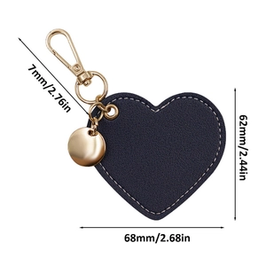 Dark blue heart-shaped leather keychain with white stitching and gold metal hardware