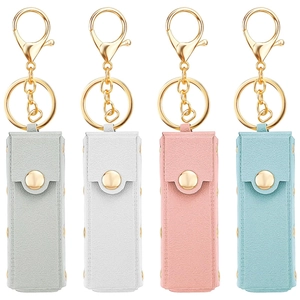 Detailed view of four colorful PU leather lipstick holders with gold rivets and keychains