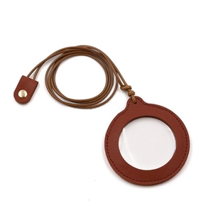 Detail of vintage neck-hanging magnifier with brown leather cover and long cord