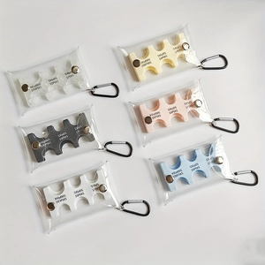 Flat lay of Japanese coin organizers in six colors showing internal PVC slots and metal snaps
