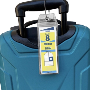 Vertical clear PVC luggage tag with secure steel wire loop hanging on a blue suitcase handle