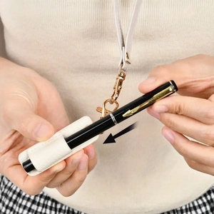 Cream leather pen holder with lanyard and metallic ring for easy access and carrying