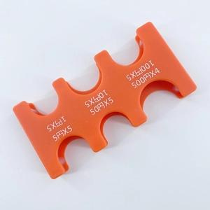 Detailed view of orange plastic Japanese coin organizer showing six slots for JPY currency